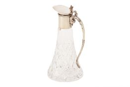 A SILVER PLATED MOUNTED CUT GLASS CLARET JUG