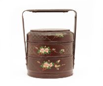 A LACQUERED AND PAINTED THREE TIERED BASKET