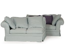 A LARGE BLUE UPHOLSTERED FOUR SEATER SOFA