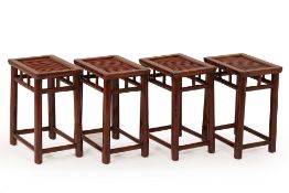 FOUR CHINESE WOODEN STOOLS & A CIRCULAR GLASS TABLE
