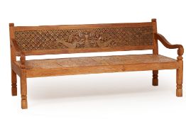 A LARGE CARVED TEAK BENCH