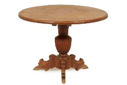 A CIRCULAR TEAK CENTRE TABLE