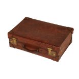 AN ANTIQUE LEATHER SUITCASE