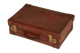 AN ANTIQUE LEATHER SUITCASE