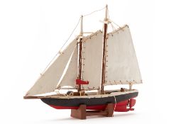 A RUSTIC HANDMADE WOODEN MODEL OF A SAILING BOAT