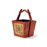 A RED LACQUERED FLORAL BUCKET