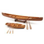 A SCALE MODEL OF A ROWING BOAT AND A CANOE