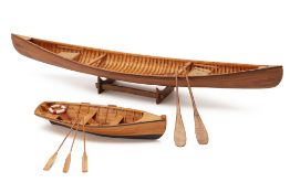 A SCALE MODEL OF A ROWING BOAT AND A CANOE