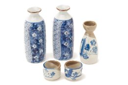 A SAKE SET AND TWO BLUE AND WHITE SAKE BOTTLES