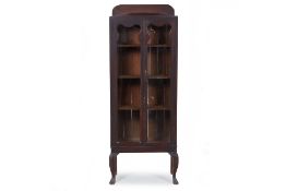 A GLAZED DISPLAY CABINET OR BOOKCASE