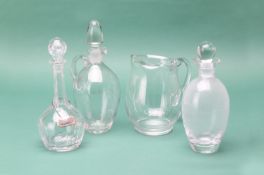 A GROUP OF GLASS DECANTERS AND A JUG