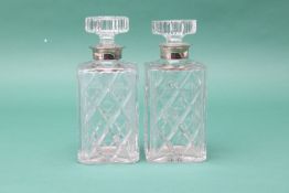 A PAIR OF SILVER MOUNTED CUT GLASS DECANTERS