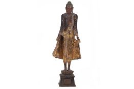 A LARGE BURMESE CARVED AND LACQUERED WOOD STANDING BUDDHA