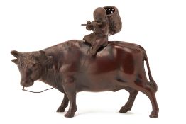 A JAPANESE CAST METAL MODEL OF A BOY RIDING AN OX