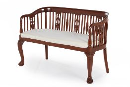 A CANED HARDWOOD SETTEE