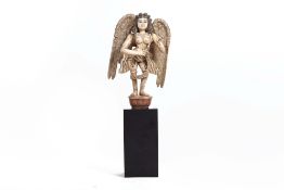 A SOUTH INDIAN CARVED AND PAINTED WOOD ANGEL