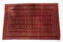 A RED BOKHARA TYPE WOOL RUG