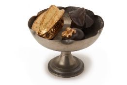 A PEWTER PEDESTAL BOWL AND CAST METAL FRUIT