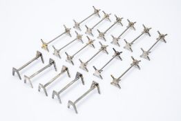 A LARGE SET OF TWELVE SILVER PLATED KNIFE RESTS