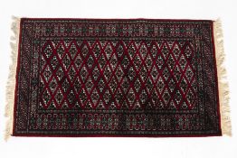 A RED GROUND WOOL RUG