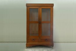 A GLAZED TEAK WARDROBE