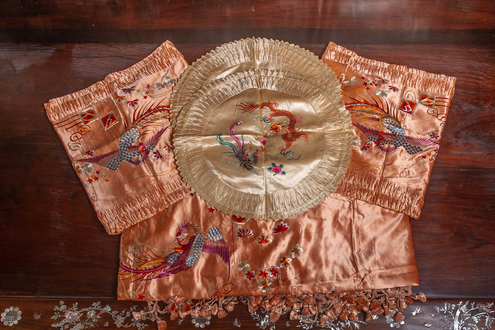 A GROUP OF EMBROIDERED SILK CUSHION COVERS AND A BED COVER