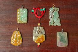 A GROUP OF FIVE CARVED JADE PENDANTS