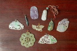 A SMALL GROUP OF CARVED AND PIERCED JADE PENDANTS