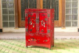 A SMALL RED LACQUERED CHINESE CABINET