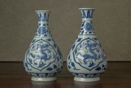 A NEAR PAIR OF BLUE AND WHITE PEAR SHAPED VASES
