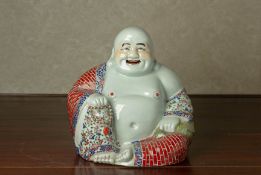 A FAMILLE ROSE PORCELAIN MODEL OF A BUDAI