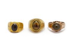 A GROUP OF THREE GOLD CABOCHON SET RINGS
