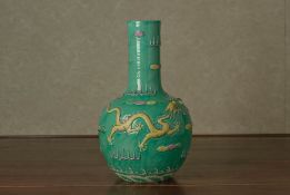 A MOULDED AND ENAMELLED BOTTLE VASE