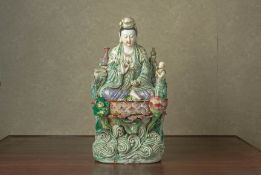 A LARGE ENAMELLED FIGURE OF GUANYIN ON LOTUS BASE