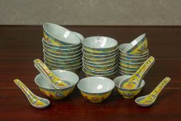 A CHINESE YELLOW GROUND FAMILLE ROSE PART DINNER SERVICE