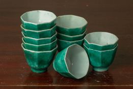 A SET OF THIRTY GREEN GLAZED OCTAGONAL TEA BOWLS