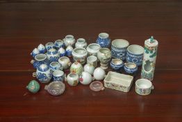 A LARGE COLLECTION OF PORCELAIN AND OTHER BIRD FEEDERS