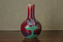 A FLAMBE GLAZED BOTTLE VASE