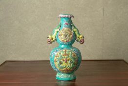 A MOULDED TURQUOISE GROUND FAMILLE ROSE VASE