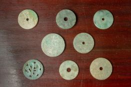 A GROUP OF EIGHT CARVED JADE DISKS