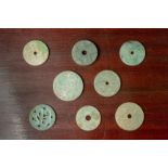 A GROUP OF EIGHT CARVED JADE DISKS