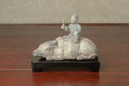 A BLUE AND WHITE PORCELAIN MODEL OF A BOY RIDING AN OX