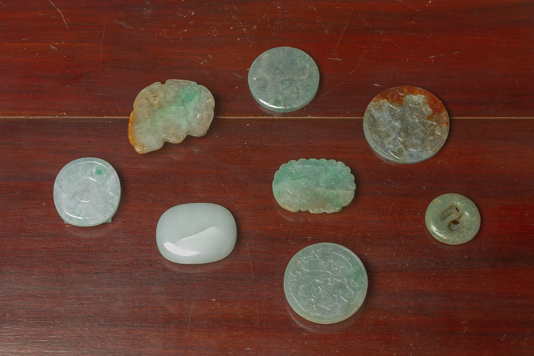 A GROUP OF EIGHT JADE BELT BUCKLES AND DISKS