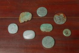 A GROUP OF EIGHT JADE BELT BUCKLES AND DISKS
