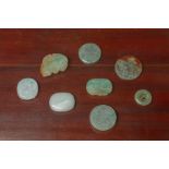 A GROUP OF EIGHT JADE BELT BUCKLES AND DISKS