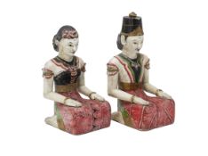 A PAIR OF INDONESIAN CARVED AND PAINTED LORO BLONYO FIGURES