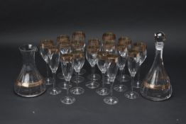 A SET OF ITALIAN GILT DECORATED WINE GLASSES AND DECANTERS