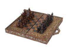 AN INDONESIAN CARVED WOOD CHESS SET