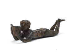 A BRONZE MODEL OF A BOY WITH A BOOK