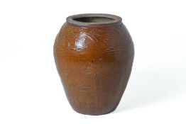 A LARGE BROWN GLAZED JAR